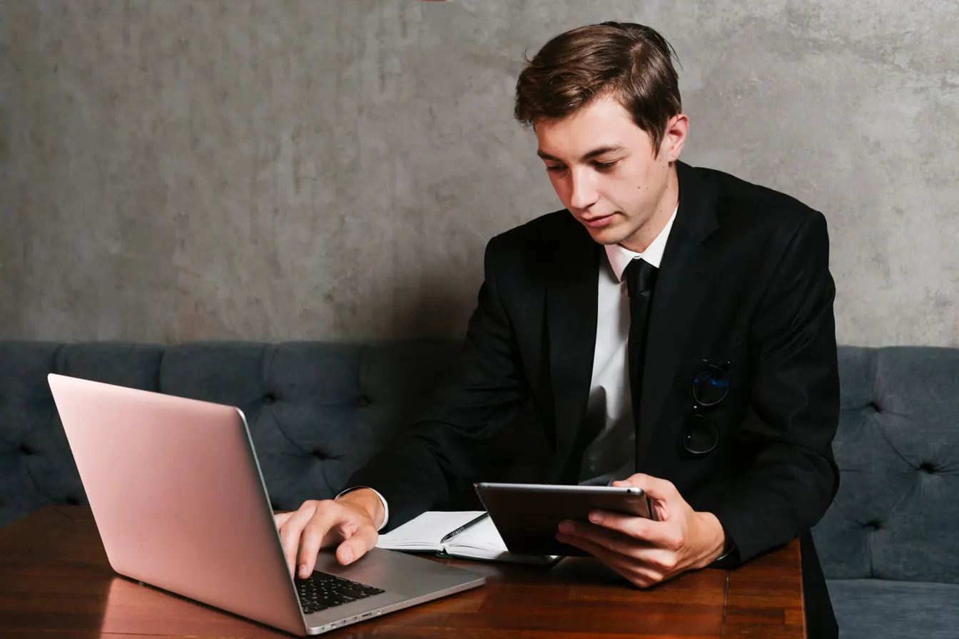 Man using a laptop and a tablet computer