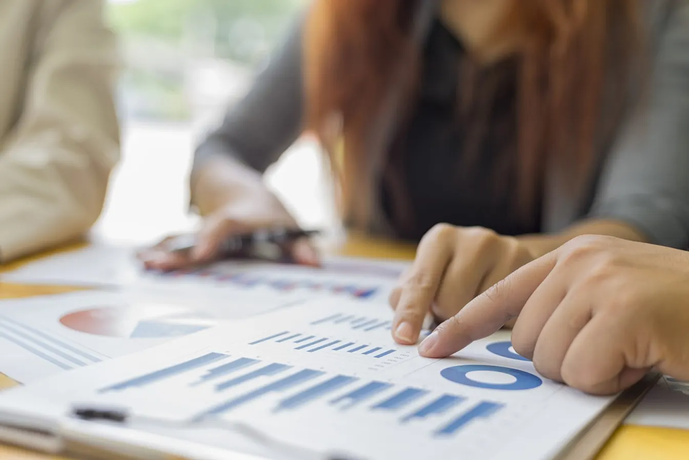 people analyzing business graphs