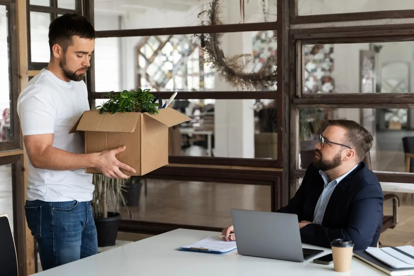 Two male employees talking to each other