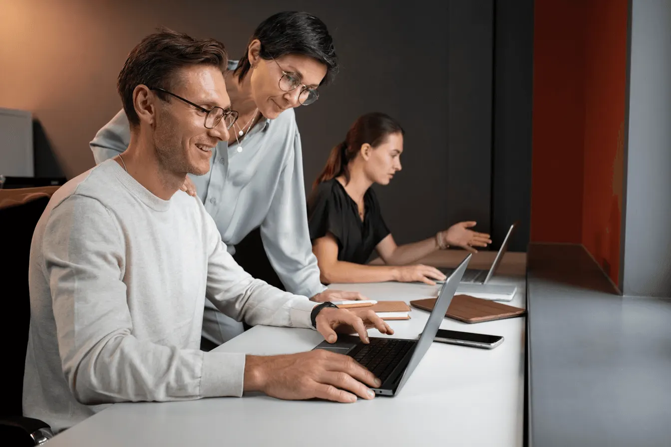 coworkers looking at a laptop