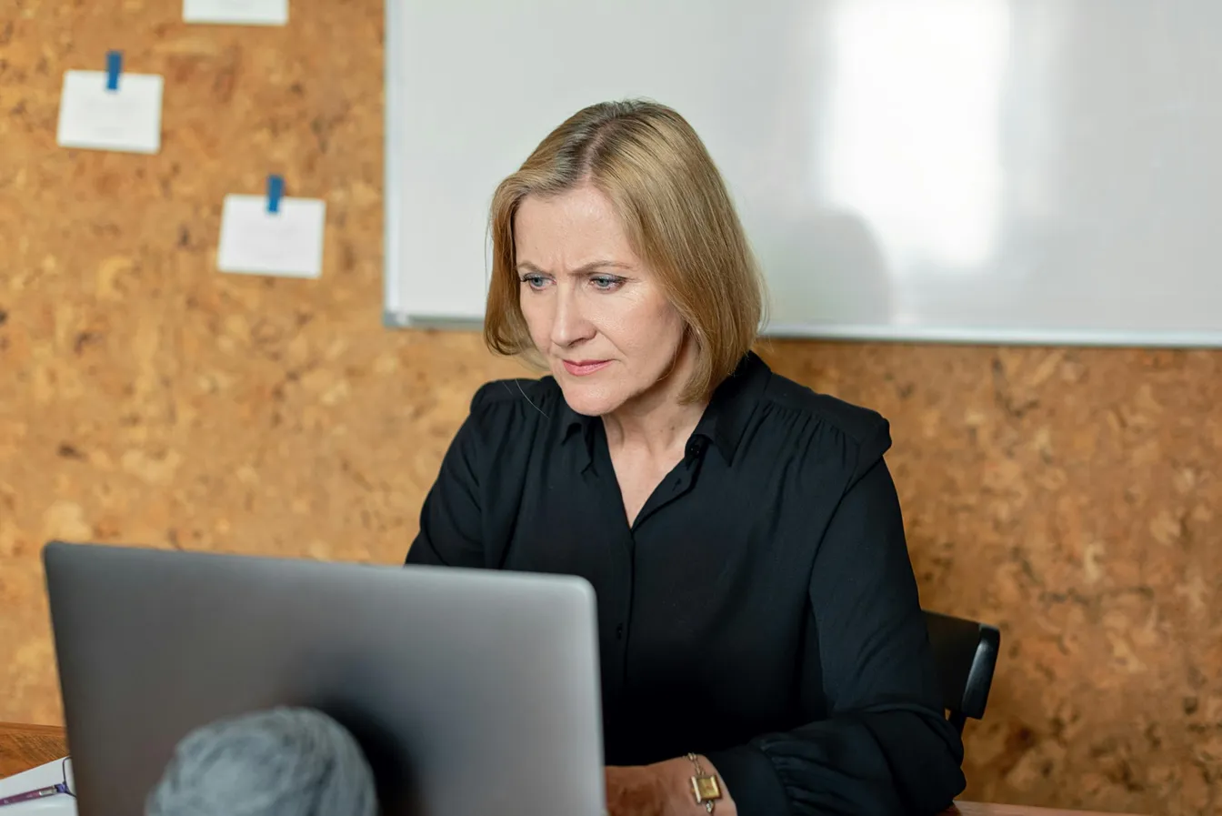 Female office worker using a laptop