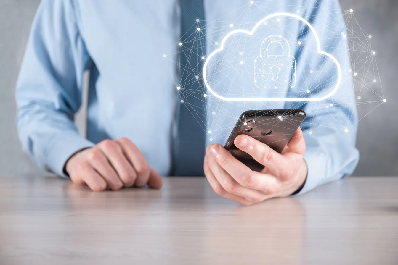 Businessman using a cloud security app on his phone