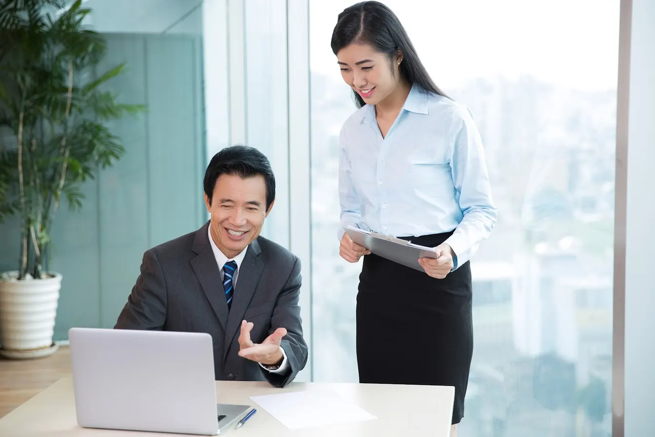Male supervisor discussing work with female employee