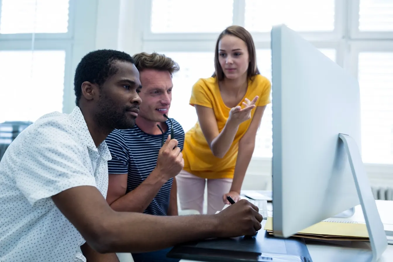 coworkers looking at a computer