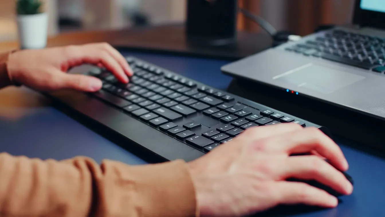 IT employee using a keyboard and a mouse