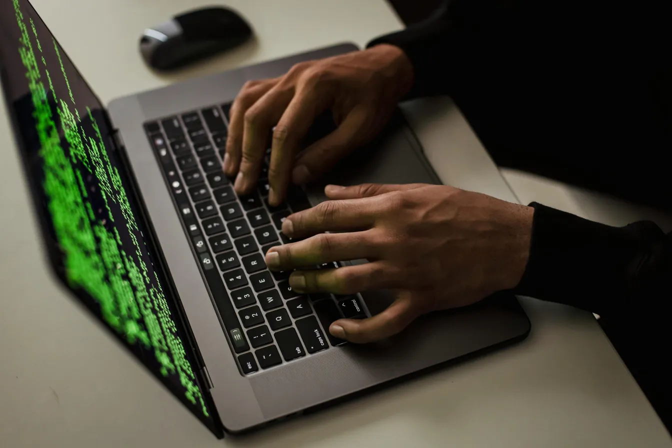 Man writing code on laptop