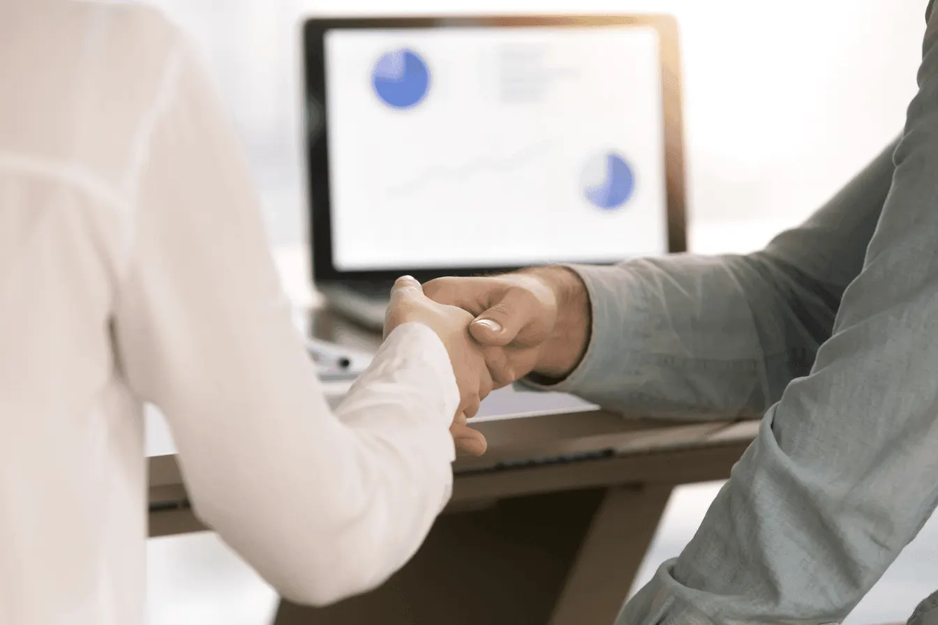 People shaking hands in an office