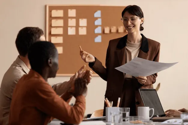 two men and a woman having a meeting and smiling